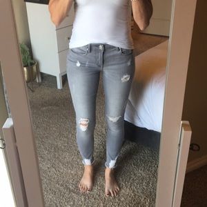Gray distressed skinny jeans. Size 2R.